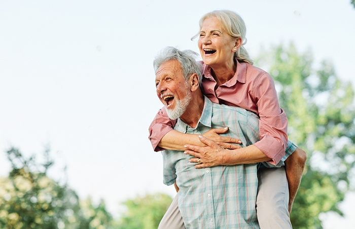 A Stamina for Men Happy active senior couple having fun outdoors. Instant erection pills for long-lasting erections